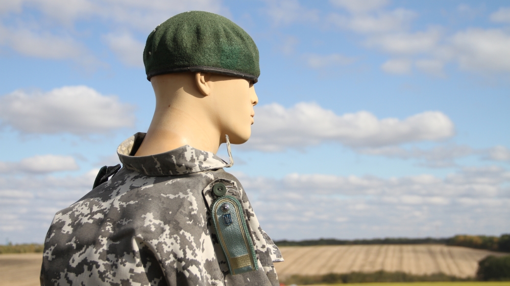 
A mannequin in a Ukrainian border guard uniform standing on a watch tower [Agnieszka Pikulicka-Wilczewska/Al Jazeera]
