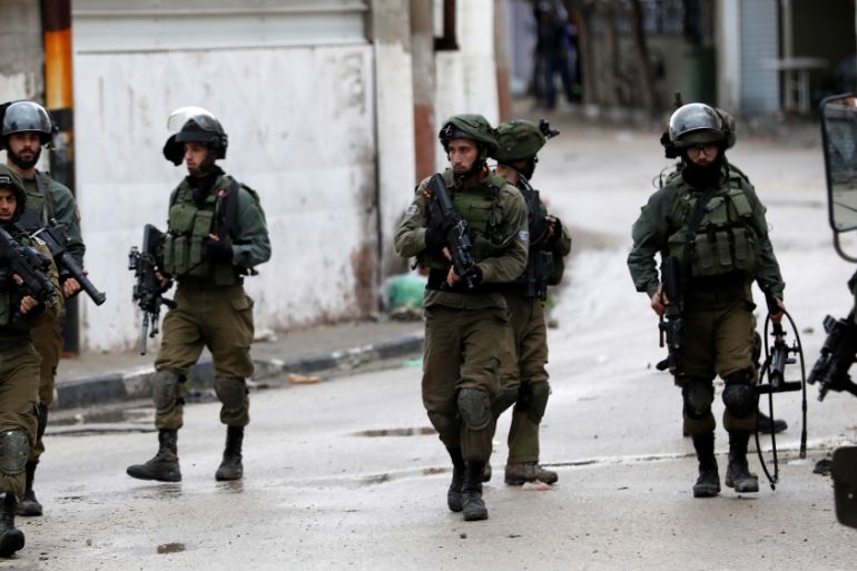 Israeli soldiers are seen during clashes with Palestinians in the West Bank city of Jenin