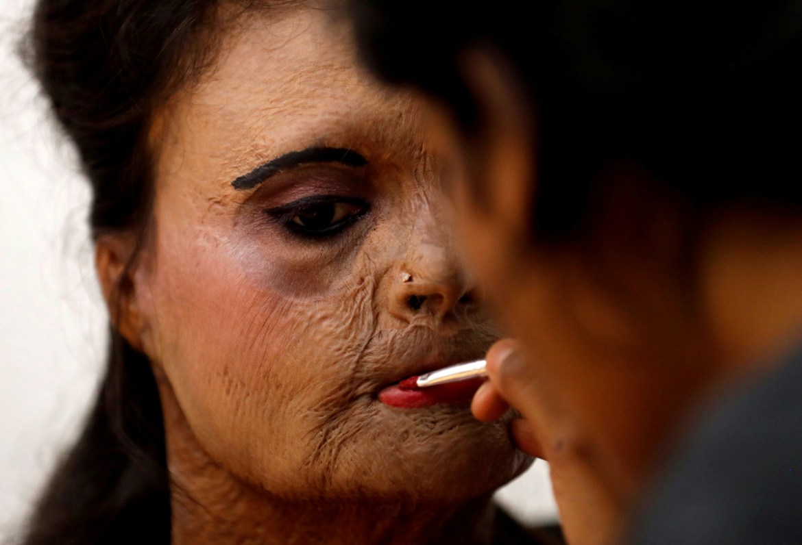 An acid attack survivor has her makeup done backstage prior to a fashion show to mark International Women''s Day in Mumbai. In India, hundreds of women have held street plays to highlight domestic viol