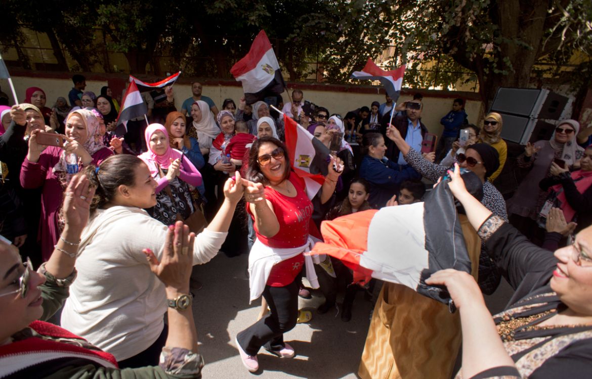 Women chant national songs after they cast their vote in front of a polling station during the first day of the presidential election in Cairo, Egypt, Monday, March 26, 2018. Egyptians head to the pol