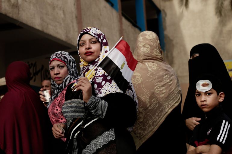 Egyptian women wait in line to vote outside a polling station at a school in the Omraniyah district of Giza, Egypt. [Nariman El-Mofty/AP Photo]