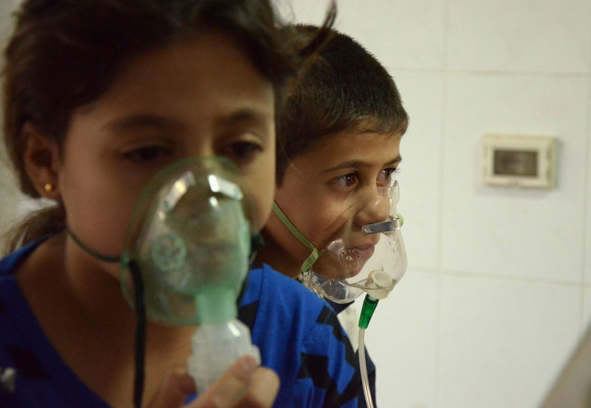 Children, affected by what activists say was a gas attack, breathe through oxygen masks in the Damascus suburb of Saqba, August 21, 2013. Syria''s opposition accused government forces of gassing hundre