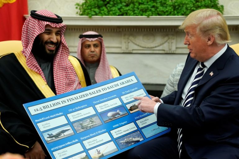U.S. President Donald Trump holds a chart of military hardware sales as he welcomes Saudi Arabia''s Crown Prince Mohammed bin Salman in the Oval Office at the White House in Washington