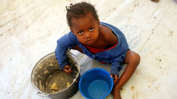 A Congolese child, whose family fled from ethnic fighting in Democratic Republic of Congo by boat, eats a meal at UNHCR reception center in Kyangwali refugee settlement camp