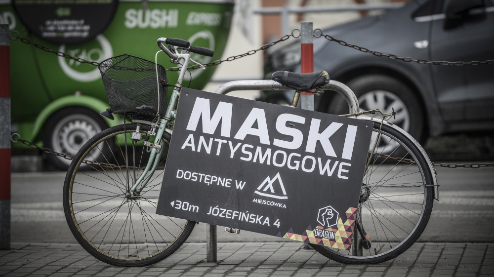 A sign advertising pollution masks is seen in Krakow [Jaap Arriens/Al Jazeera]
