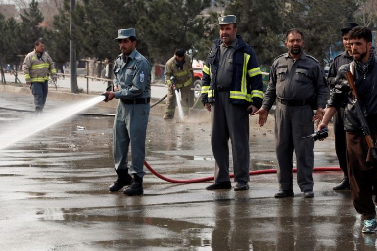 Afghan fire fighters clean the site of a suicide bomb attack near a Shi''ite mosque in Kabul