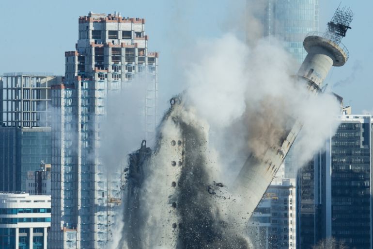 The unfinished and abandoned TV tower collapses during a controlled demolition in Yekaterinburg