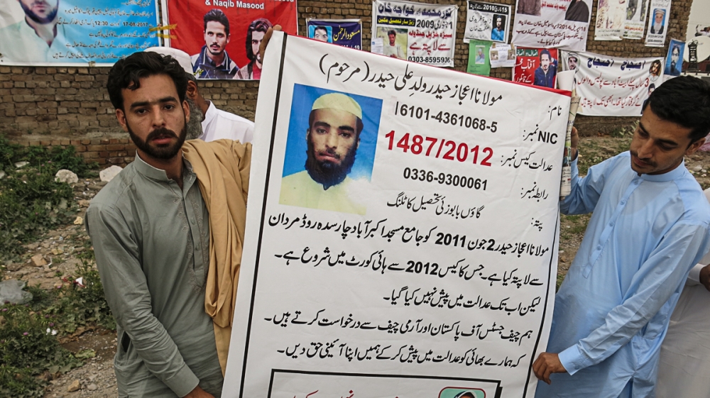 Owais Haider, left, has been searching for his brother Ijaz Haider, who went missing from the northwestern city of Mardan in 2011 [Asad Hashim/Al Jazeera]