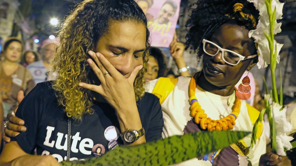 Anielle Silva, left, sister of Franco, cries at a memorial in Rio de Janeiro on Saturday [Diego Herculano/AFP]