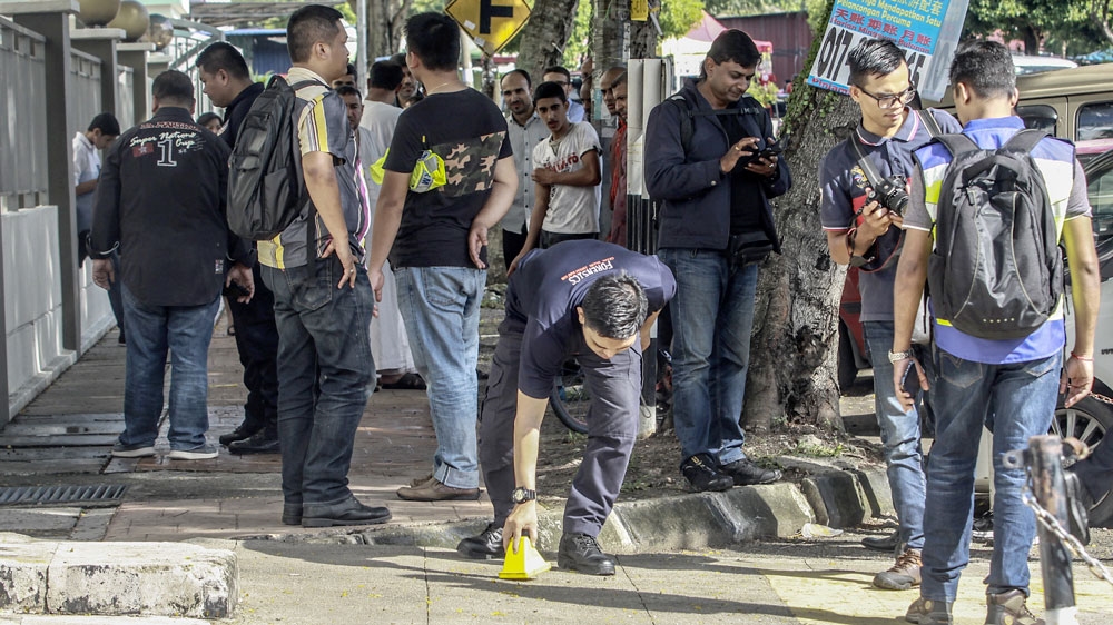Malaysian forensic officers collected evidence at the crime scene where Palestinian scientist Fadi al-Batsh was killed [EPA]