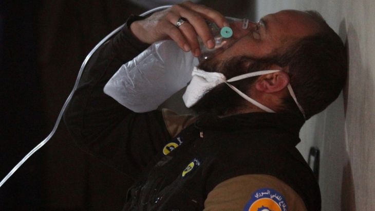A civil defence member breathes through an oxygen mask, after what rescue workers described as a suspected gas attack in the town of Khan Sheikhoun in rebel-held Idlib
