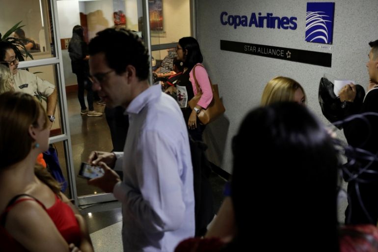 People gather at the gates of Copa Airlines headquarters in Caracas