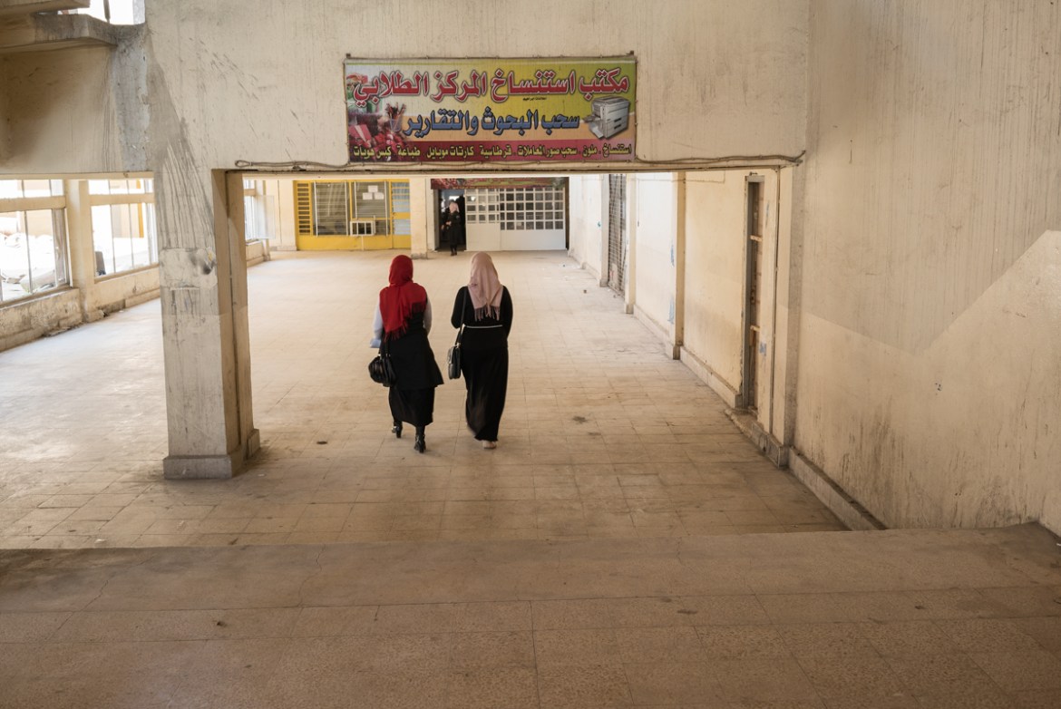 Girls walk inside the main building of the University of Mosul. The campus reopened its doors in March of 2017, however there are buildings severely damaged, including the library. During Daesh occupa