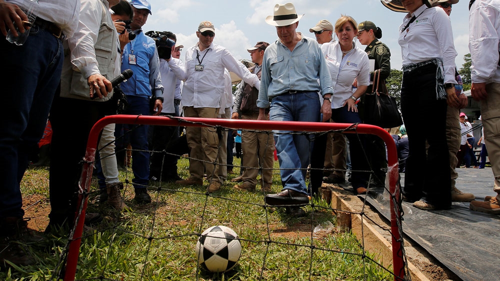 Santos kicks a football into a goal during a visit to the FARC concentration zone in Putumayo, Colombia in February 2017 [File: Jaime Saldarriaga/Reuters] 