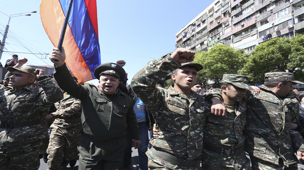 Members of the military took part in anti-government protests in Yerevan on Monday [Vahram Baghdasaryan/Reuters] 