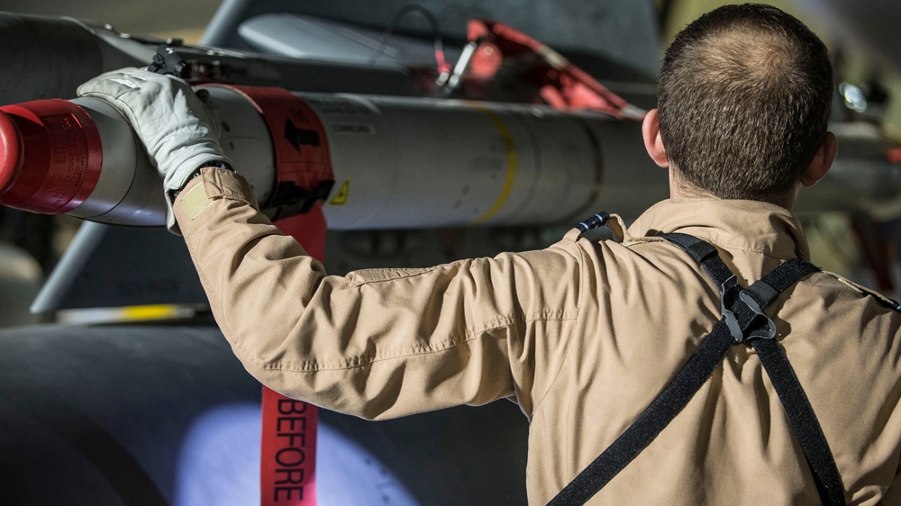 A British pilot checks the weapons on his Tornado jet in Cyprus after its mission in Syria [AP]