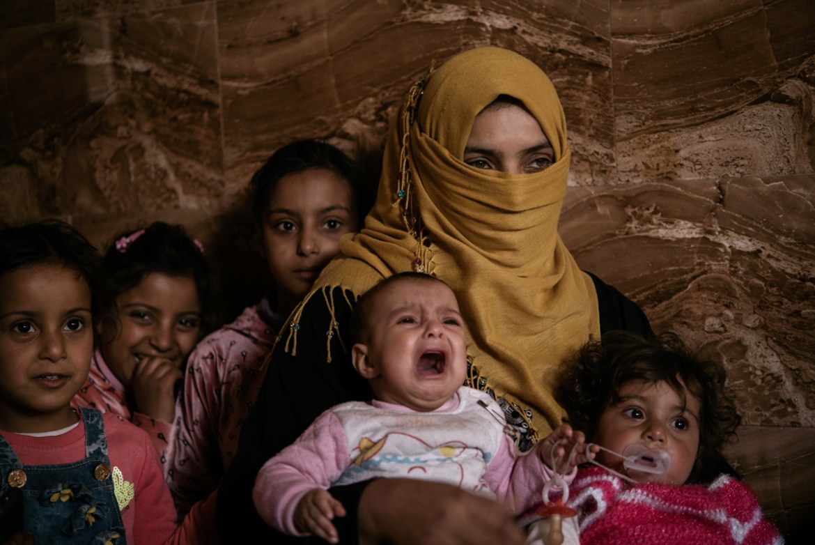 Amina, 31 and her children in their house in Al Tanak. In the early stages of the operation, Amina’s husband, a Daesh member, got killed. She then left Mosul wearing the Daesh imposed black niqab and