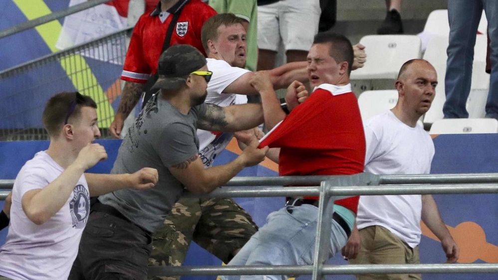 Russian and English fans fight in the stands after the Euro 2016 football match between England and Russia, at the Velodrome stadium in Marseille, France [AP Photo/Thanassis Stavrakis]