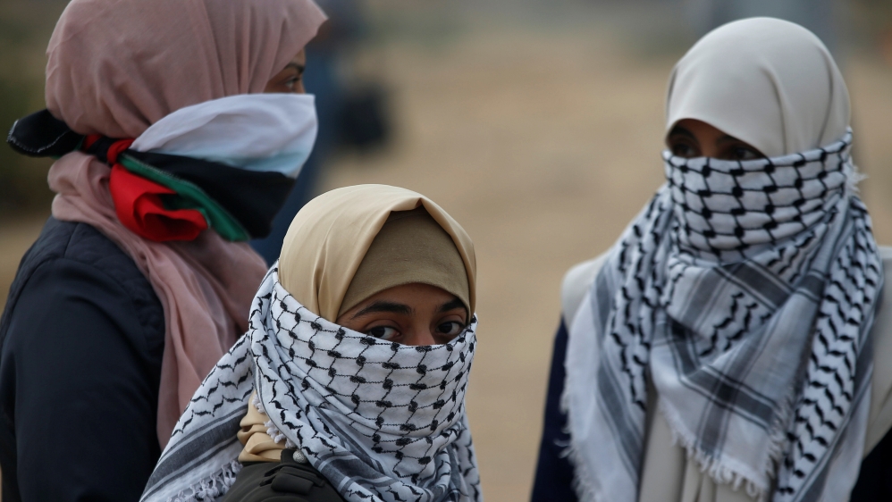Palestinian women gather near the Israel-Gaza border during a tent city protest demanding the right to return to their homeland, east of Gaza City [Mohammed Salem/Reuters]