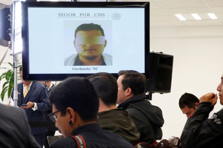 A screen displays the photo of the alleged murderer of journalist Javier Valdez during a news conference at Mexico''s Interior Ministry building in Mexico City