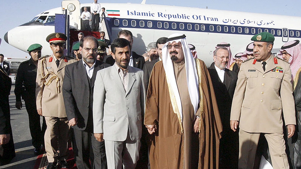 King Abdullah hand-in-hand with Iran's President Ahmadinejad in Riyadh in 2007 [File: EPA]
