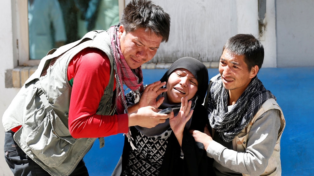Relatives of the victims mourn at a hospital in Kabul [Mohammad Ismail/Reuters]