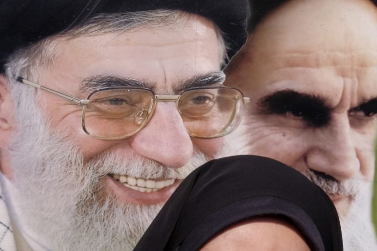 Iranian schoolgirl stands in front of Khomeini, and Khamenei