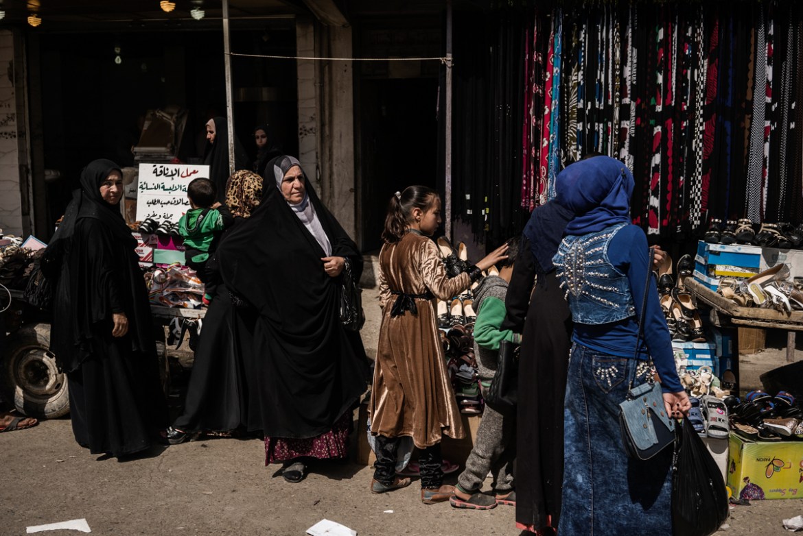 Women shop in a street market in Mosul East side, the least damaged part. The streets are back to normal and very busy.