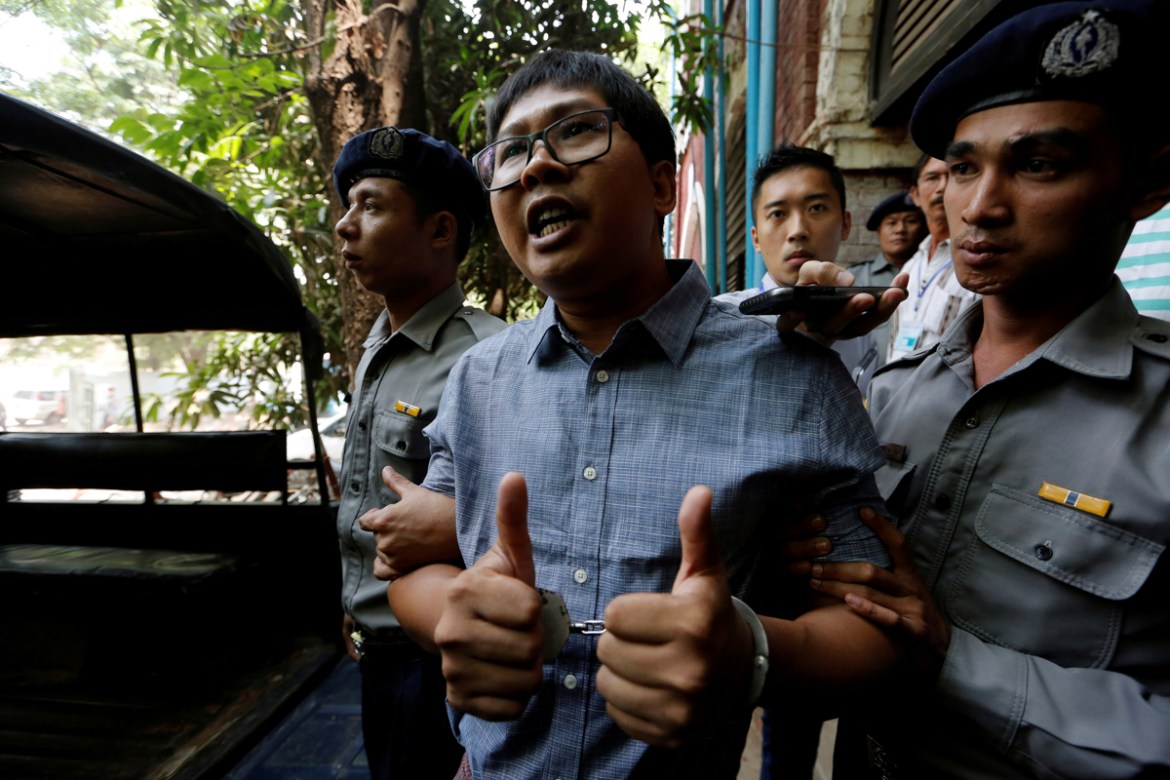 Detained Reuters journalist Wa Lone is escorted by police after a court hearing in Yangon, Myanmar April 4, 2018. REUTERS/Ann Wang TPX IMAGES OF THE DAY