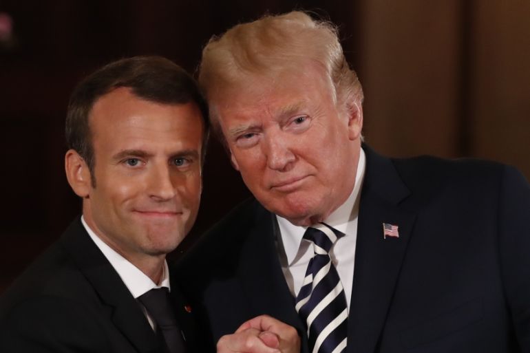 French President Emmanuel Macron clasps hands with U.S. President Donald Trump [Jonathan Ernst/Reuters]