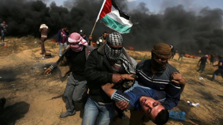 Wounded demonstrator is evacuated during clashes with Israeli troops at a protest where Palestinians demand the right to return to their homeland, at the Israel-Gaza border in the southern Gaza Strip