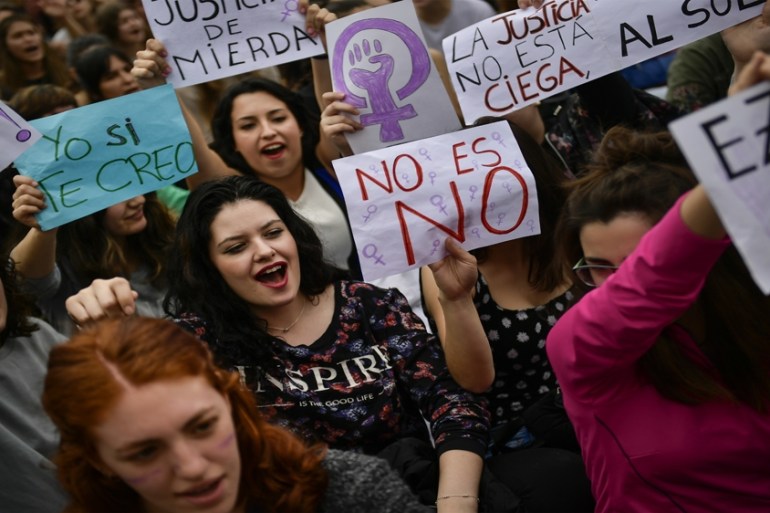 People hold signs reading ''''I believe you'''' and ''''No is No'''' during a protest in front of the Regional Court in Pamplona, northern Spain, Friday, April 27, 2018 [Alvaro Barrientos/AP]