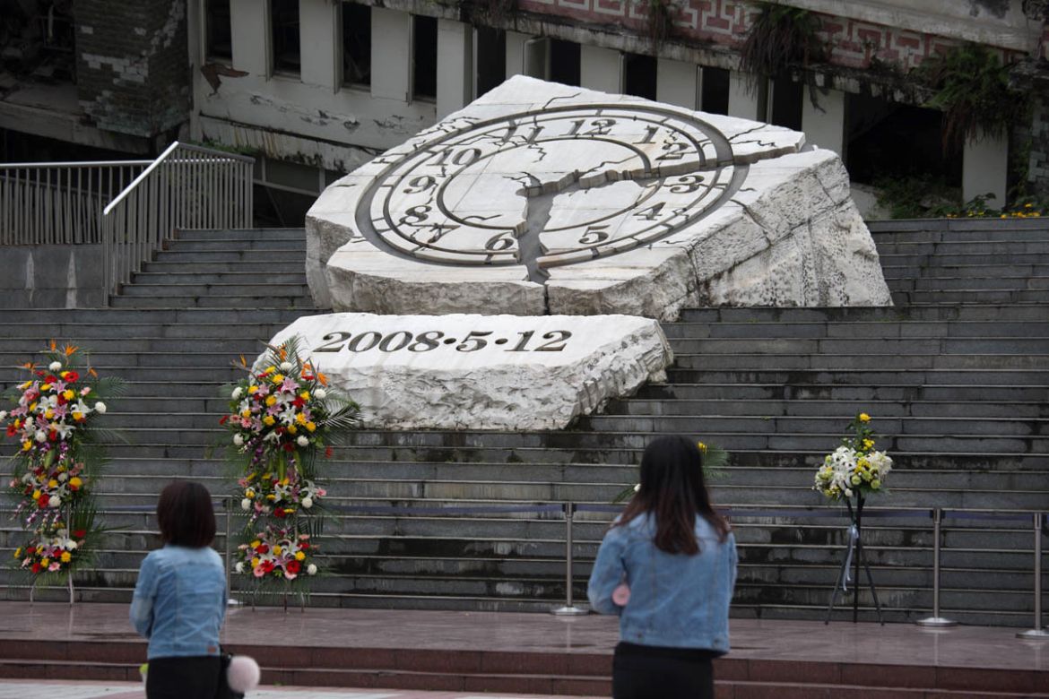 On this photo taken on May 10, 2018, visitors stood by the monument where flowers and wreath were laid by people to commemorate the earthquake victims. As the 10th anniversary is coming, the memorial