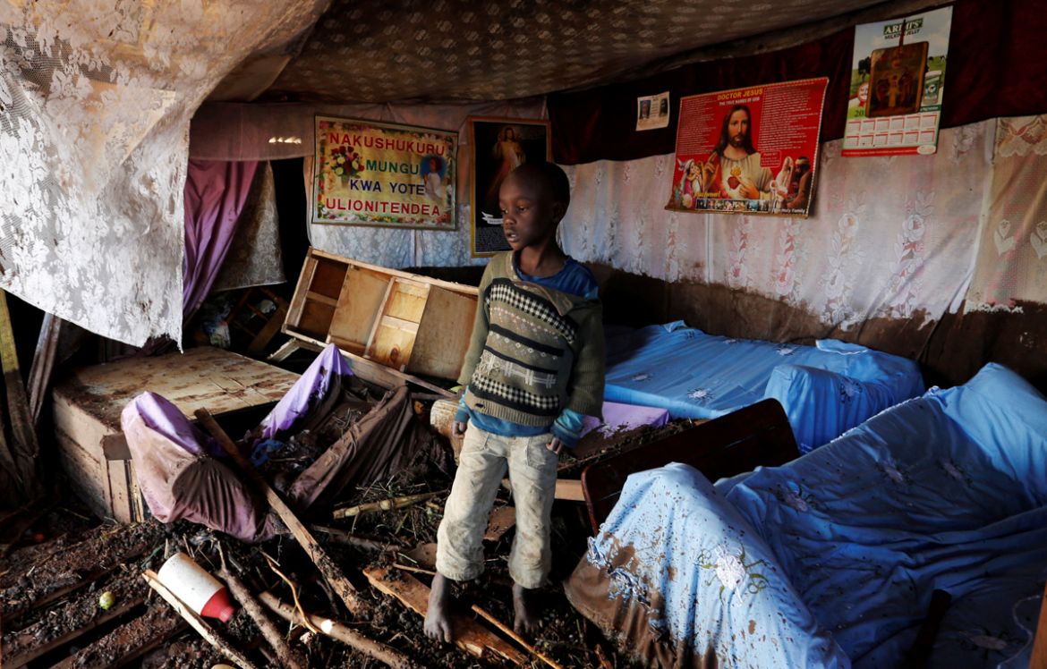 A child walks in his house, which was partly destroyed by flooding water after a dam burst, in Solio town near Nakuru, Kenya May 10, 2018. REUTERS/Thomas Mukoya