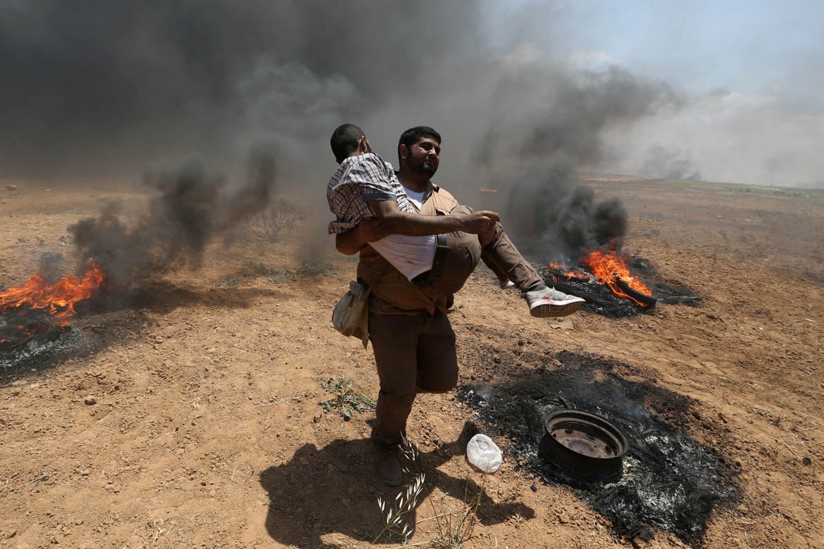 A wounded Palestinian demonstrator is evacuated during a protest against U.S. embassy move to Jerusalem and ahead of the 70th anniversary of Nakba, at the Israel-Gaza border in the southern Gaza Strip