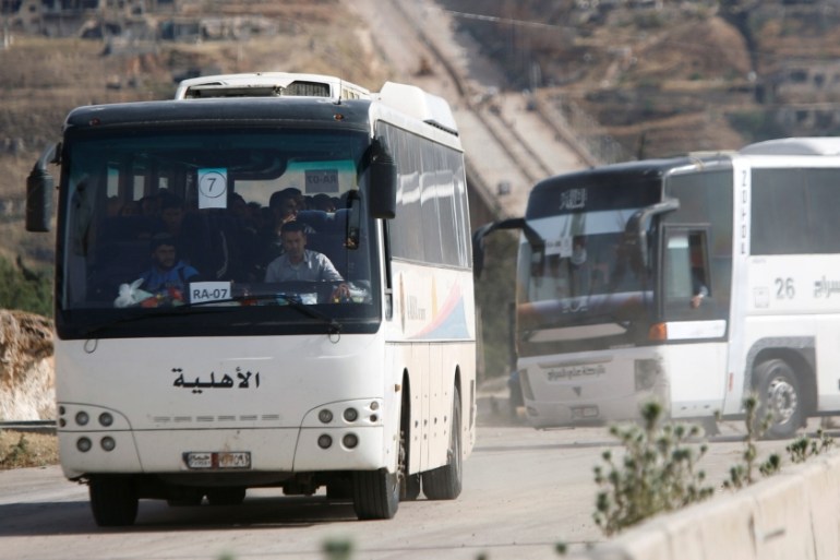 Buses carrying rebels who were evacuated with their families from al-Rastan are seen in Homs countryside