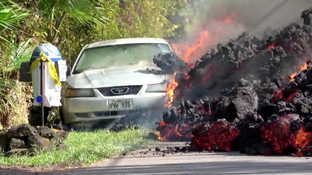 Lava engulfs a Ford Mustang in Puna, Hawaii, on May 6, 2018, in this still image obtained from a social media video [Reuters]