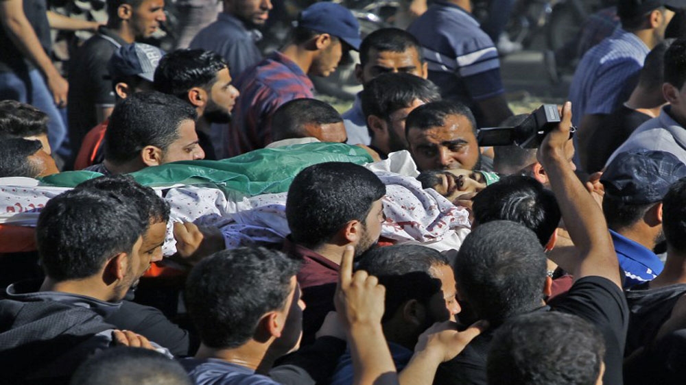 Palestinian mourners carry the body of a man killed during clashes with Israeli forces, on May 14, 2018, in Gaza City [AFP]