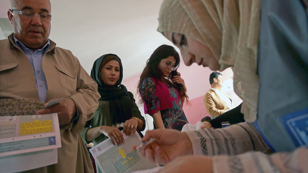  Kurdish voters cast their ballots during the Iraqi parliamentary elections at a polling station in Erbil in May 2018 [File: Gailan Haji/EPA] 