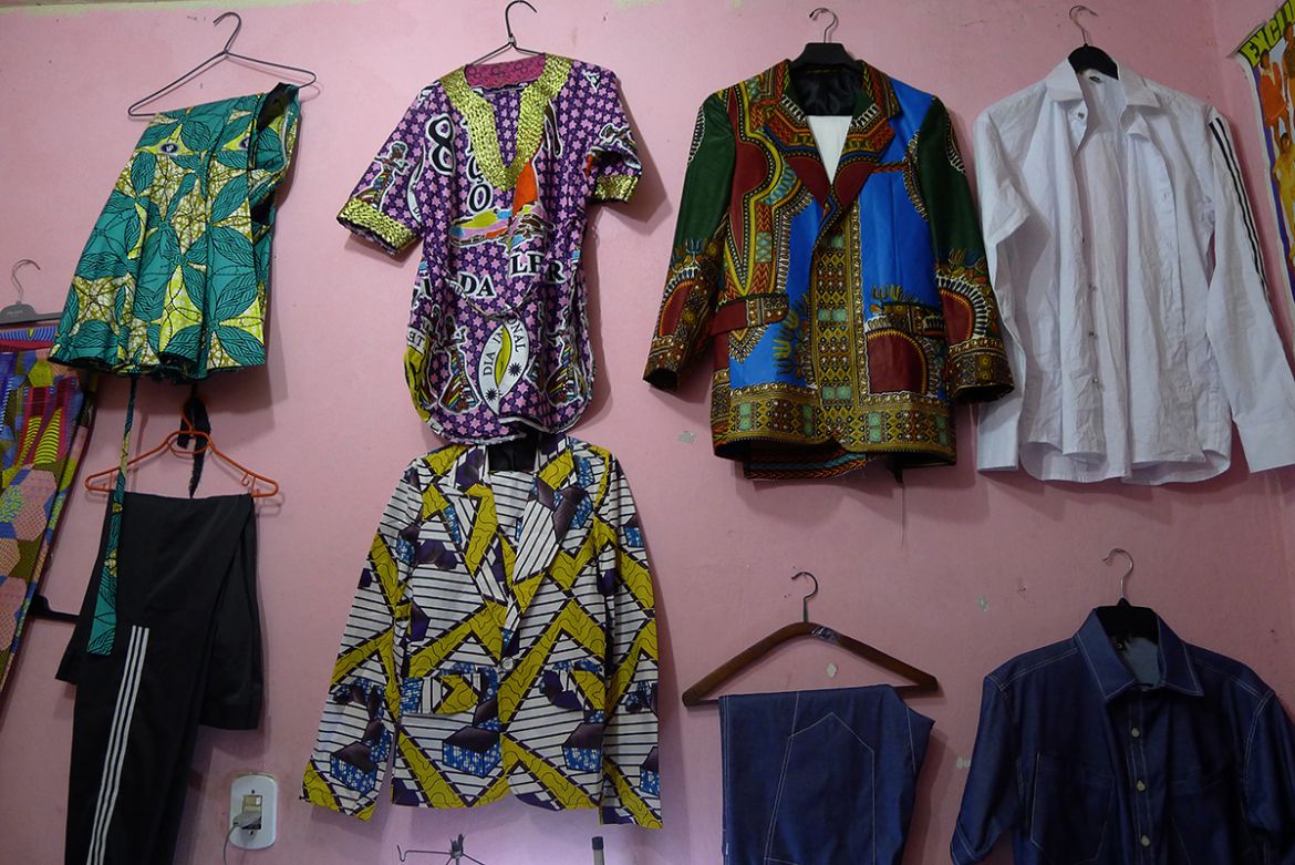 Stylist Mao Mbongo, 37, a refugee from the Democratic Republic of Congo exhibits blazers, blouses and skirts she has made in the style of her homeland for sale to her compatriots in the Cinco Bocas fa