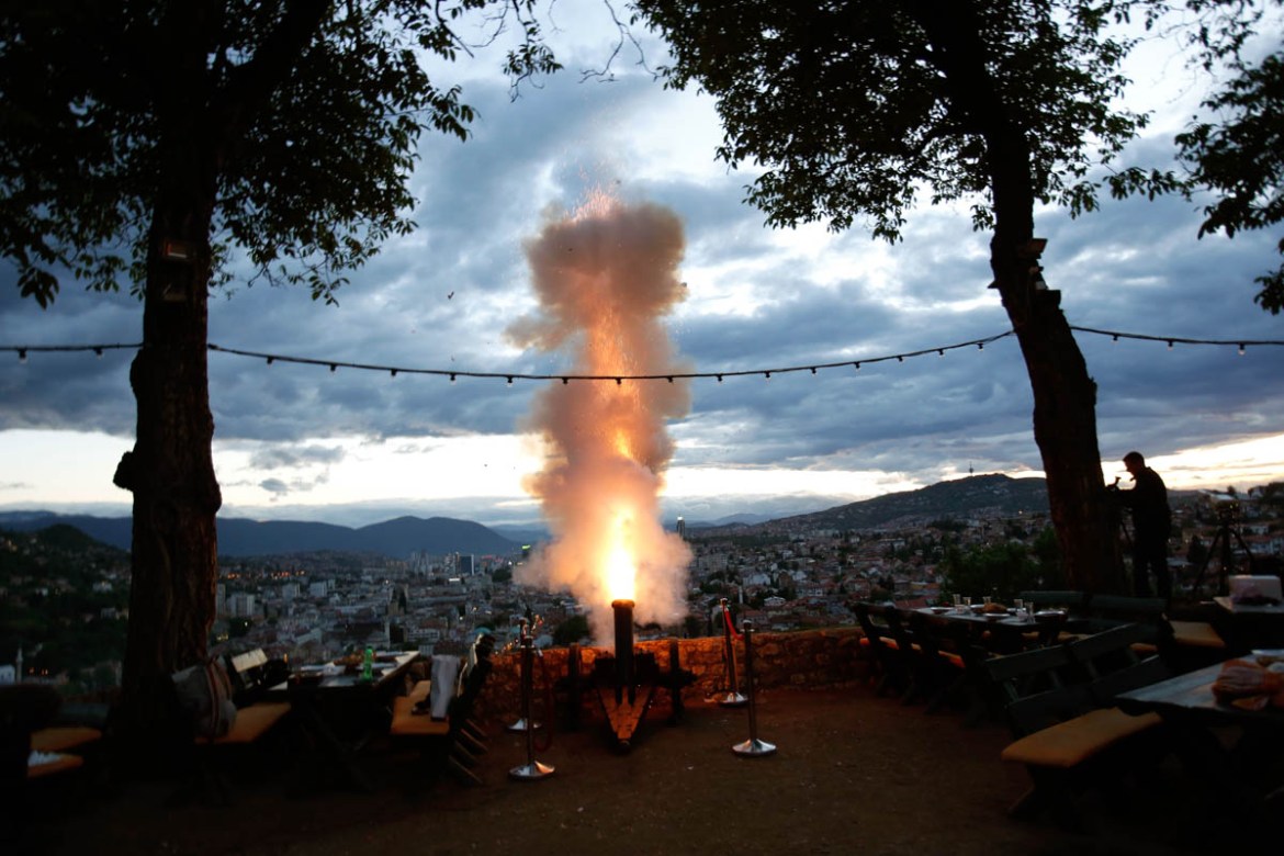 Bosnian Ramadan gunner Smail Krivic fires a round from his firework cannon to signal the end of dawn-to-dusk fast in Sarajevo, Bosnia, Wednesday evening, May 16, 2018. Muslim Bosniaks make up around 4