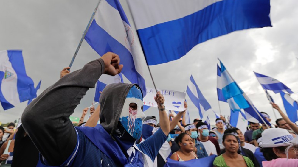 Anti-government demonstrators hold a protest demanding Nicaraguan President Daniel Ortega and his wife resign [Inti Ocon/AFP] 