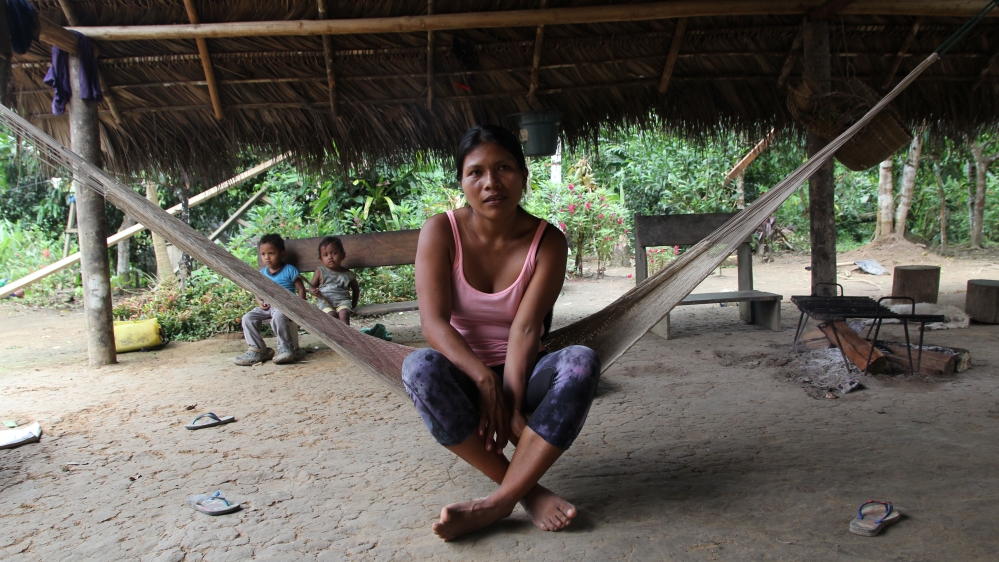 Nemonte Nenquimo sits in her home in the Waorani community of Nemonpare [Kimberley Brown/Al Jazeera]