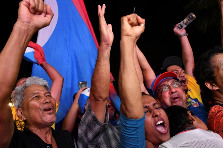 Supporters of Mahathir Mohamad celebrate in Petaling Jaya