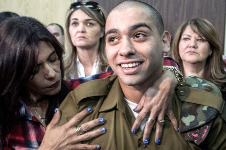 Israeli soldier Elor Azaria is embraced by his mother at the start of is sentencing hearing at a military court in Tel Aviv
