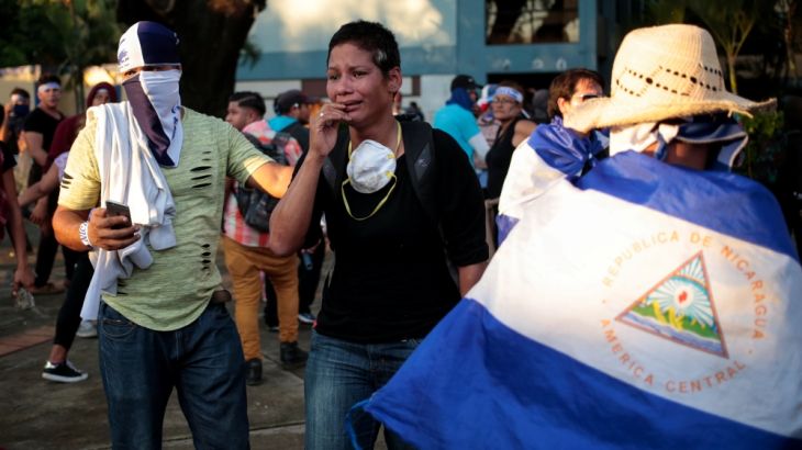 A woman cries after clashes with riot police in Managua