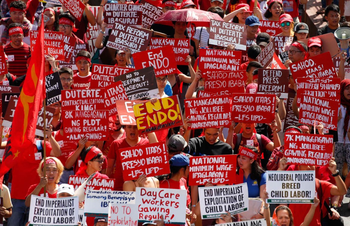 Protesters, mostly workers, march towards the Presidential Palace during the global commemoration of Labor Day Tuesday, May 1, 2018 in Manila, Philippines. About 5,000 workers and activists from vario