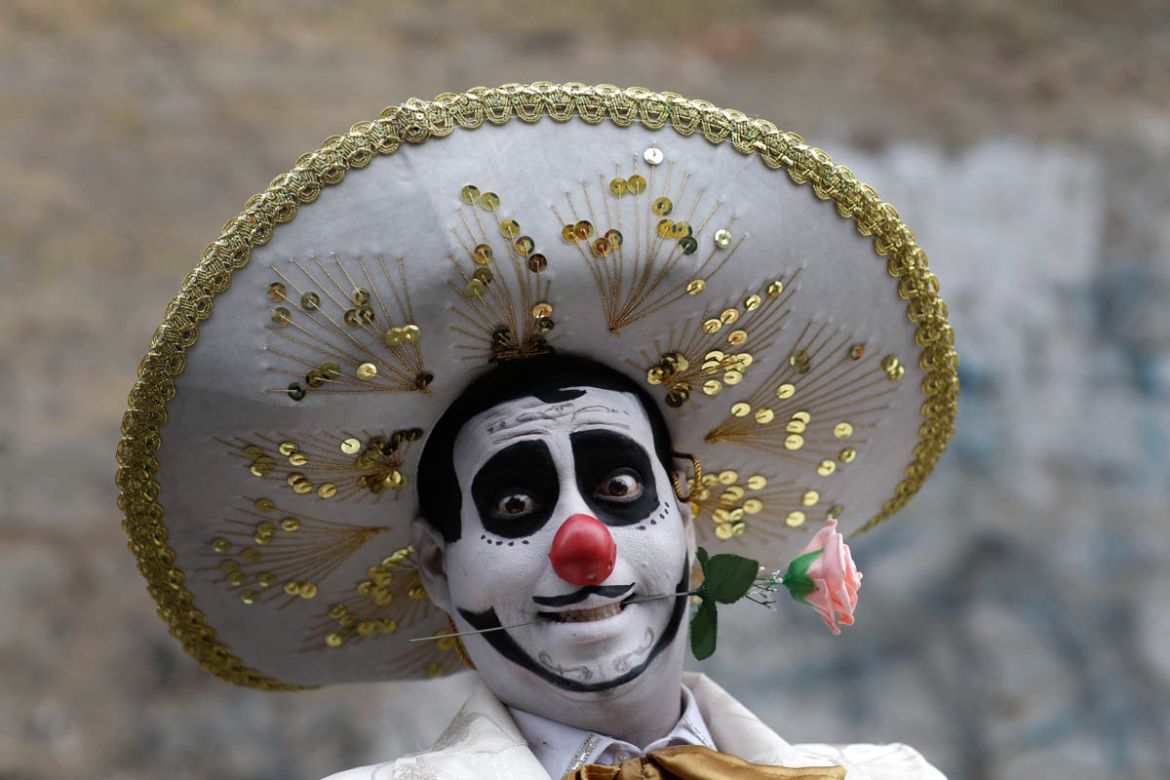 A clown smiles before celebrating Peruvian Clown Day in Lima, Peru, Friday, May 25, 2018. Hundreds of professional clowns gather annually on this date to honor the late and beloved "Tony Perejil", who