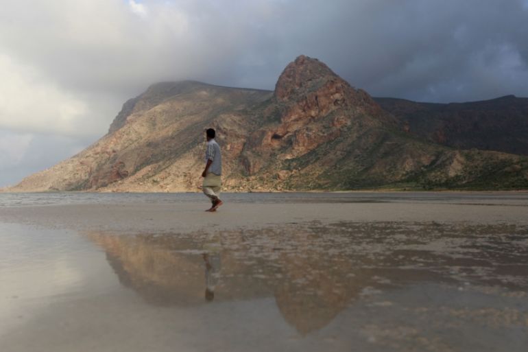 A local guide walks on the approach to Ditwa lagoon and beach near the port of Qalensiya, the second biggest town on Yemen''s Socotra island