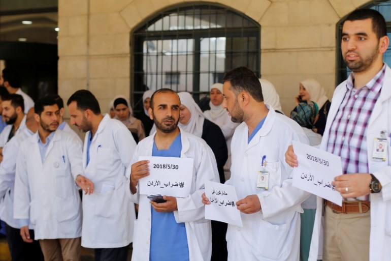 Doctors involved in the strike stand outside their workplace